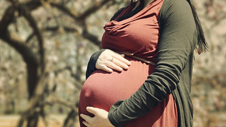 Pregnant woman holding her belly